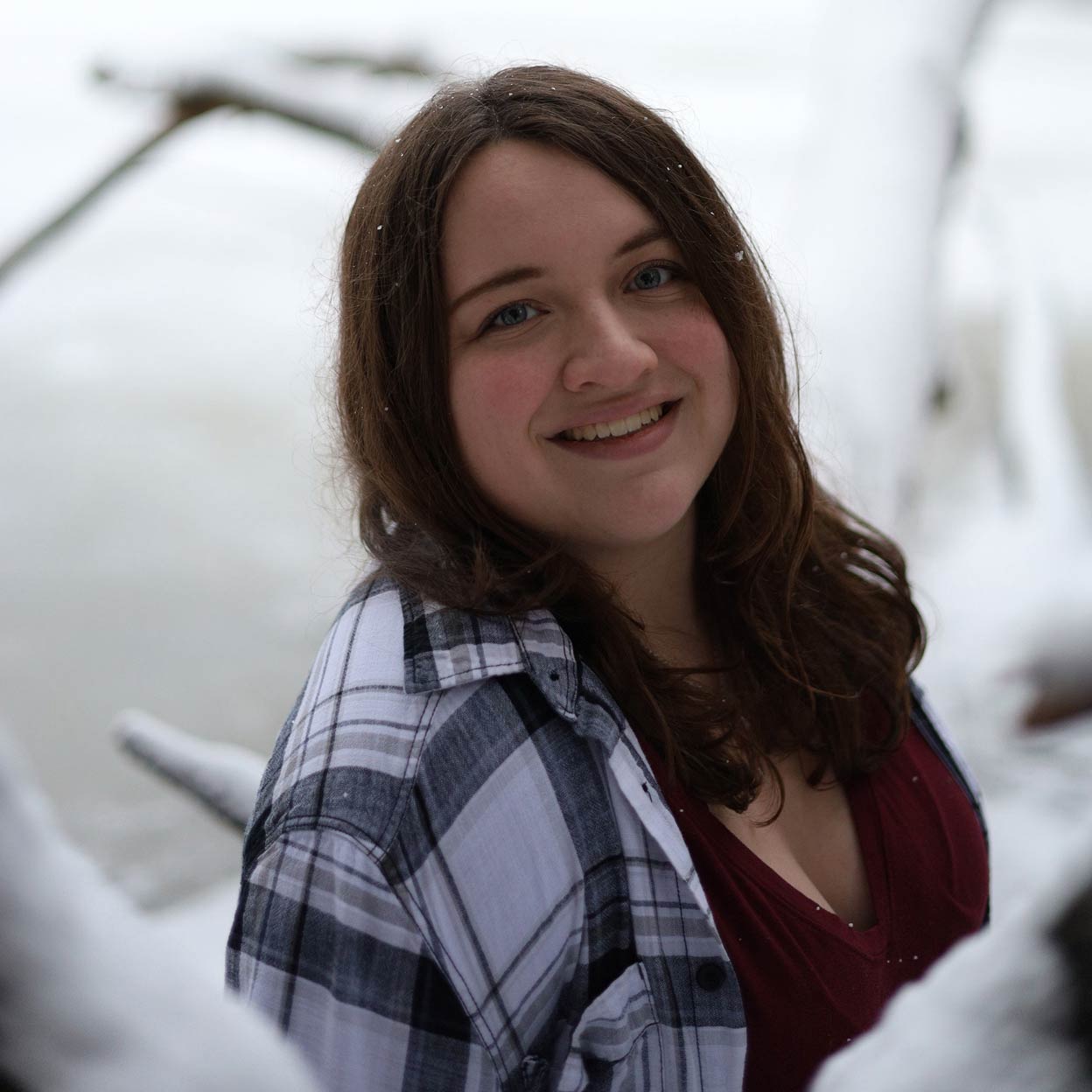 Senior portrait of my sister with a snow-covered lake behind her